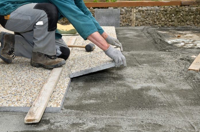 Paver,On,The,Knee,Lays,Concrete,Paving,Stone,On,The